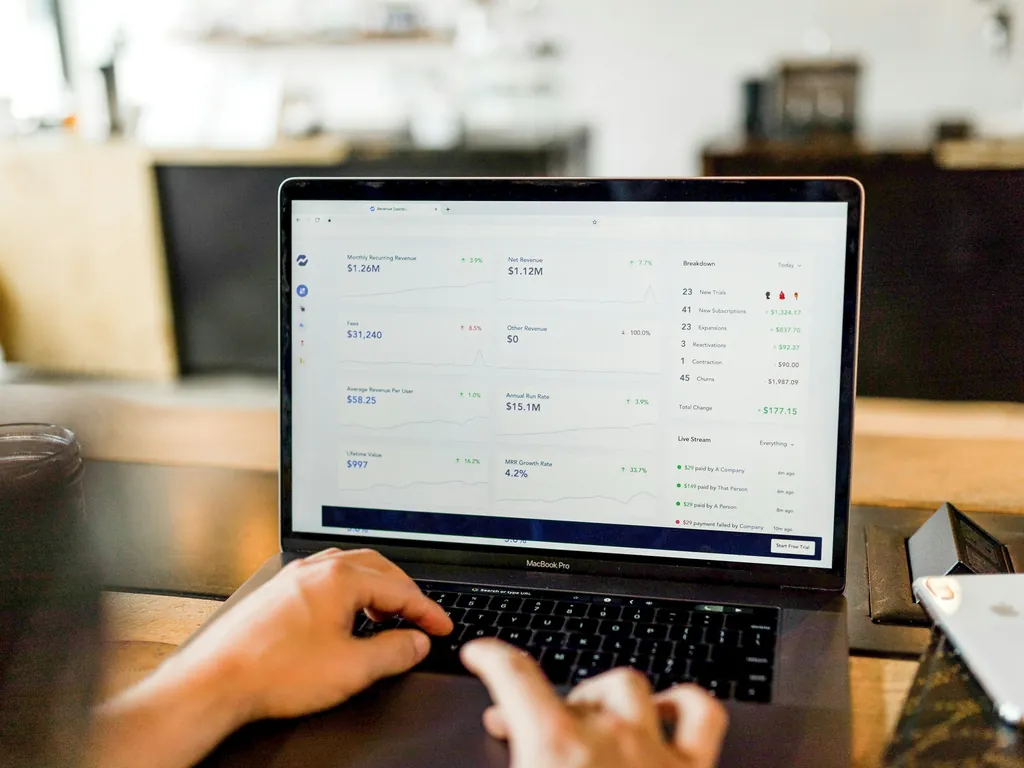 Hands on a laptop keyboard with a live dashboard on the screen.